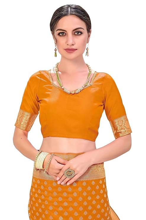 Woman wearing a orange party wear ethnic kurta style by Nishtha Chadda