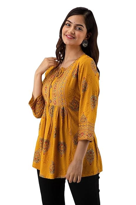 Woman wearing a orange party wear ethnic kurta style by Nishtha Chadda