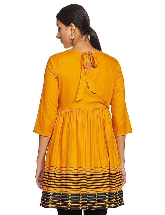 Woman wearing a mustard party wear ethnic kurta style by Nishtha Chadda