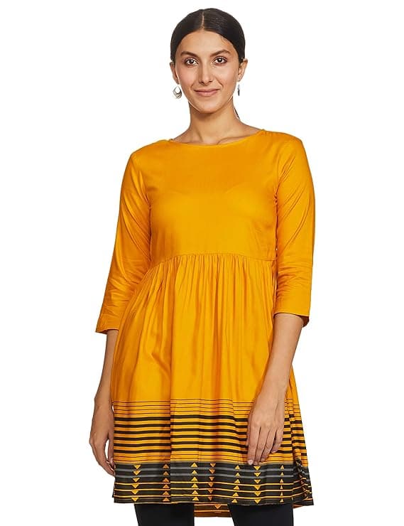 Woman wearing a mustard party wear ethnic kurta style by Nishtha Chadda