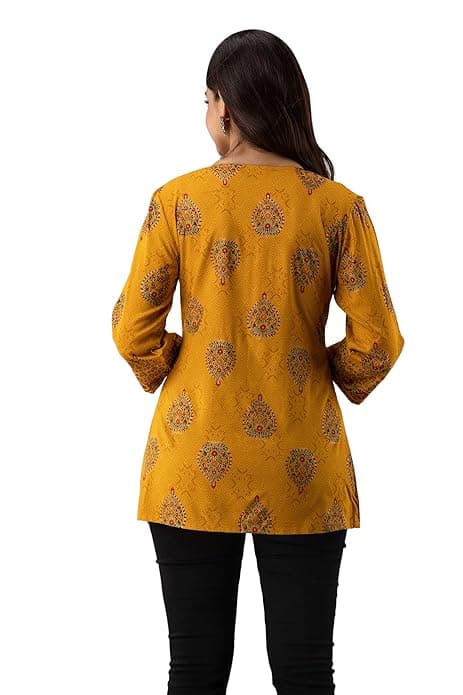Woman wearing a orange party wear ethnic kurta style by Nishtha Chadda