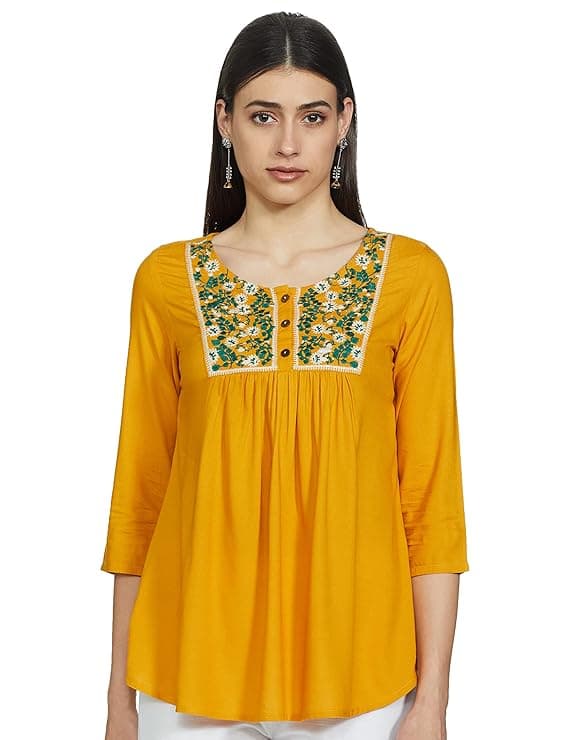 Woman wearing a mustard party wear ethnic kurta style by Nishtha Chadda