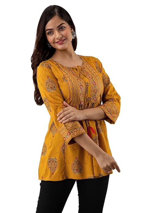 Woman wearing a orange party wear ethnic kurta style by Nishtha Chadda