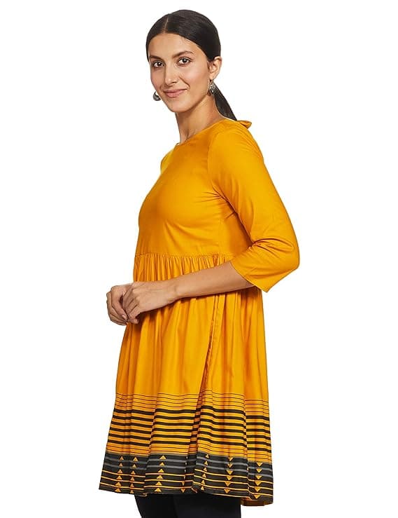 Woman wearing a mustard party wear ethnic kurta style by Nishtha Chadda