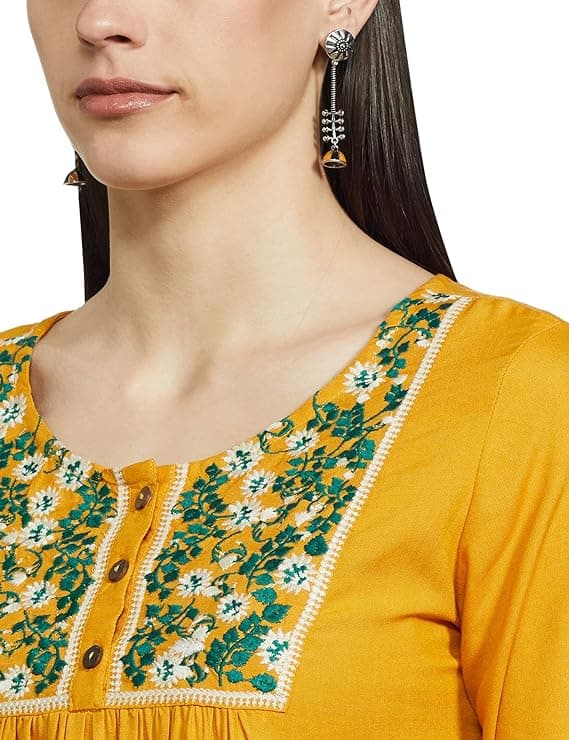 Woman wearing a mustard party wear ethnic kurta style by Nishtha Chadda