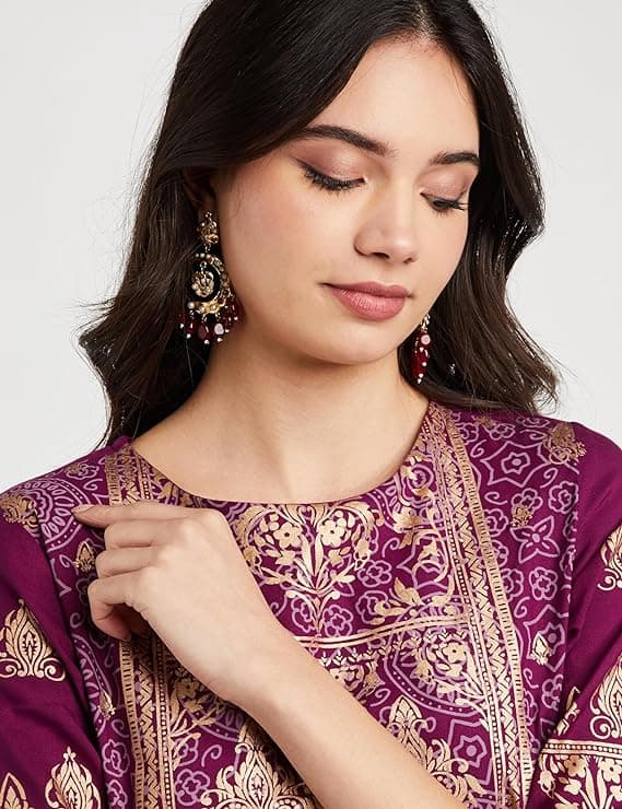 Woman wearing a maroon party wear ethnic kurta style by Nishtha Chadda