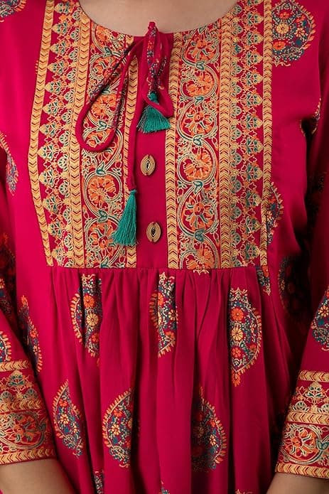 Woman wearing a red party wear ethnic kurta style by Nishtha Chadda