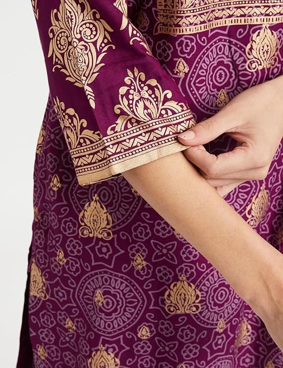 Woman wearing a maroon party wear ethnic kurta style by Nishtha Chadda