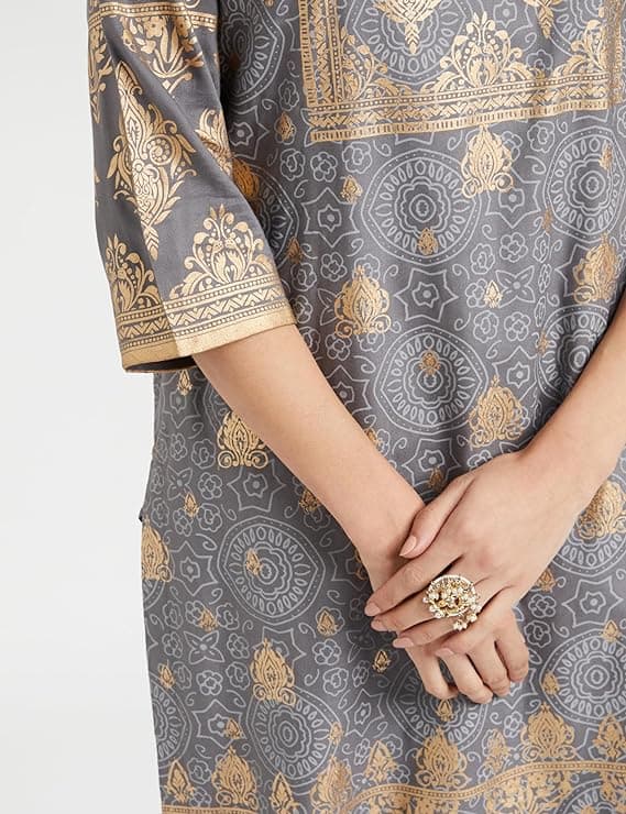 Woman wearing a grey party wear ethnic kurta style by Nishtha Chadda