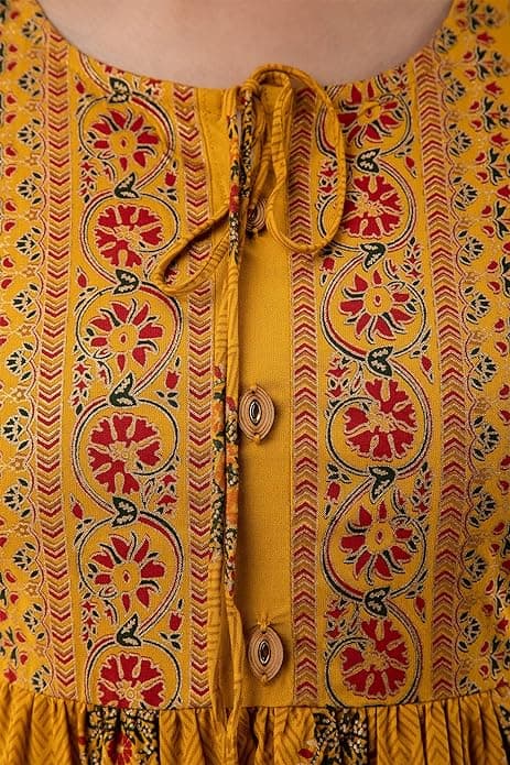 Woman wearing a orange party wear ethnic kurta style by Nishtha Chadda