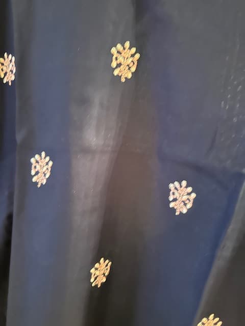 Woman wearing a grey embroidered kurti set by Nishtha Chadda