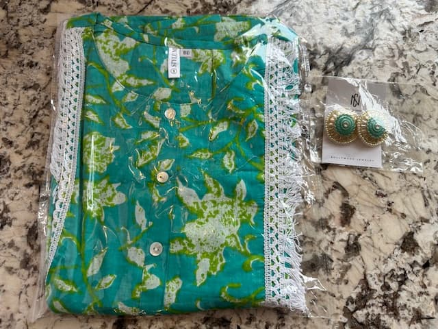 Woman wearing a teal embroidered kurti set by Nishtha Chadda