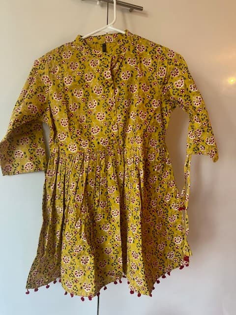 Woman wearing a brown embroidered kurti set by Nishtha Chadda