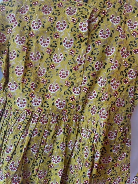 Woman wearing a olive embroidered kurti set by Nishtha Chadda