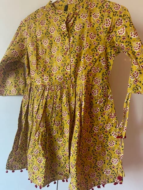 Woman wearing a brown embroidered kurti set by Nishtha Chadda