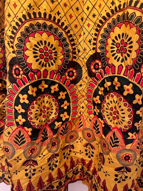 Woman wearing a orange embroidered kurti set by Nishtha Chadda
