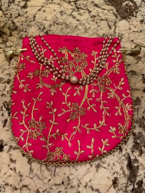 Woman wearing a red embroidered kurti set by Nishtha Chadda