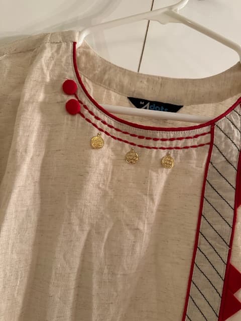 Woman wearing a brown embroidered kurti set by Nishtha Chadda