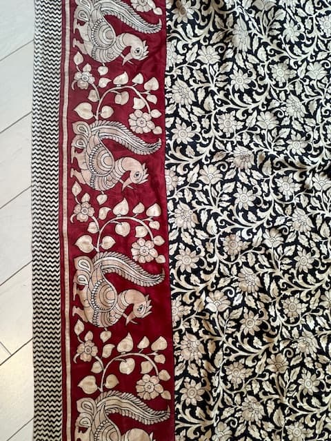 Woman wearing a maroon embroidered kurti set by Nishtha Chadda