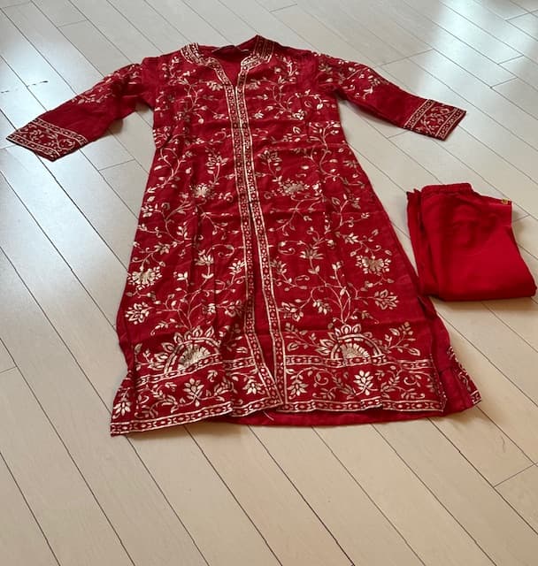 Woman wearing a maroon embroidered kurti set by Nishtha Chadda