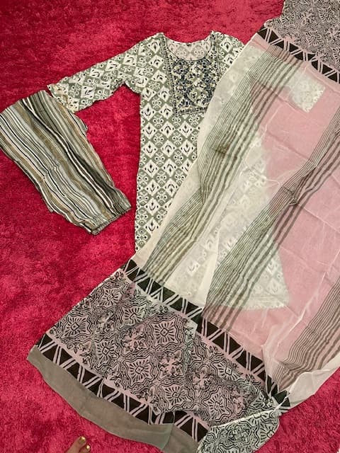 Woman wearing a red embroidered kurti set by Nishtha Chadda