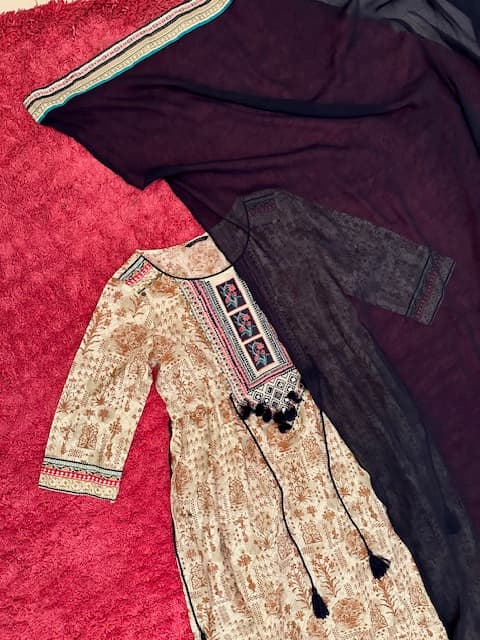 Woman wearing a red embroidered kurti set by Nishtha Chadda