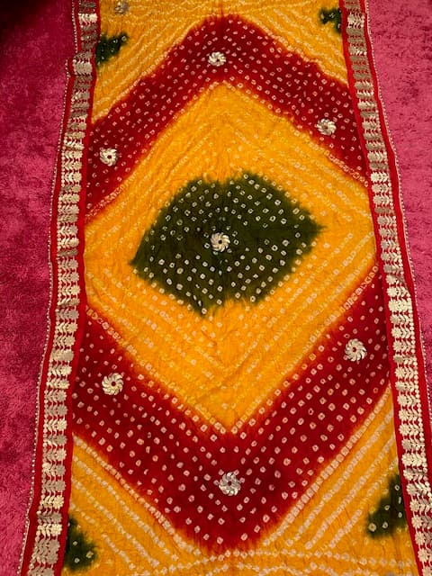 Woman wearing a orange embroidered kurti set by Nishtha Chadda