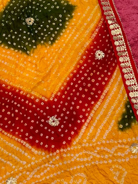 Woman wearing a orange embroidered kurti set by Nishtha Chadda