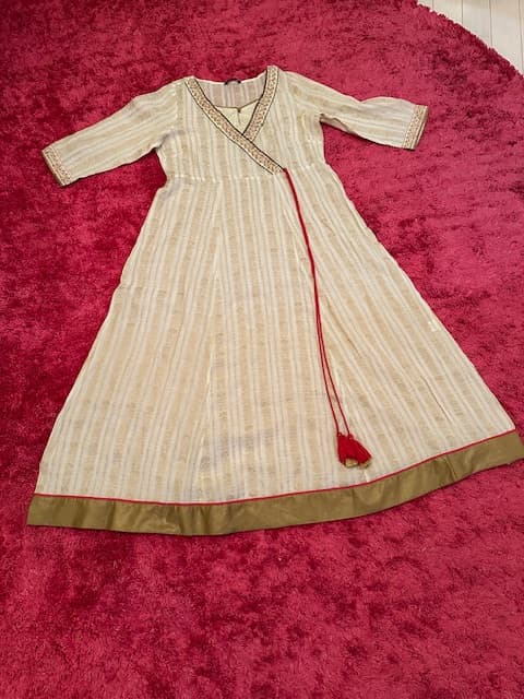 Woman wearing a maroon embroidered kurti set by Nishtha Chadda