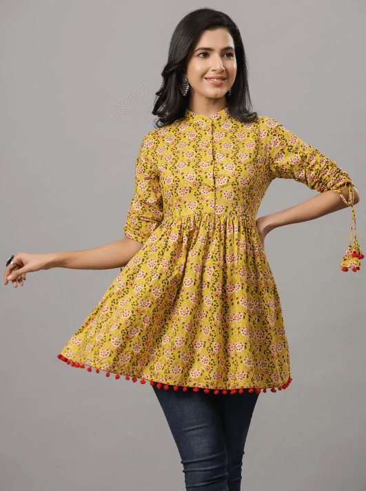 Woman wearing a mustard indian kurti for women by Nishtha Chadda