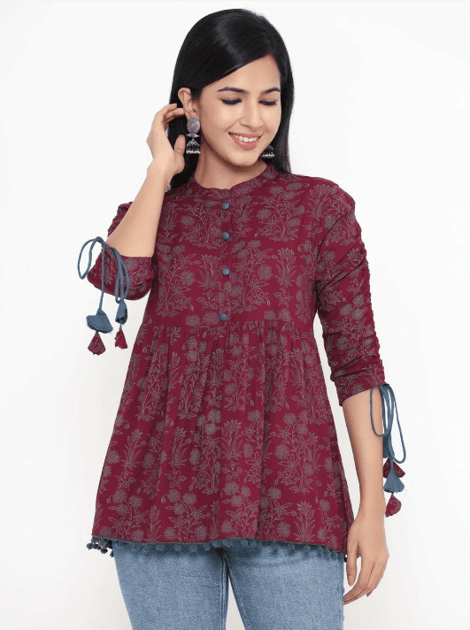 Woman wearing a maroon indian kurti for women by Nishtha Chadda
