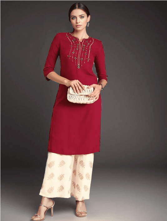 Woman wearing a red indian kurti for women by Nishtha Chadda