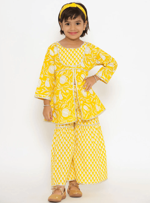 Woman wearing a yellow indian kurti for women by Nishtha Chadda