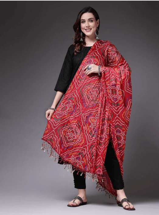 Woman wearing a red indian kurti for women by Nishtha Chadda