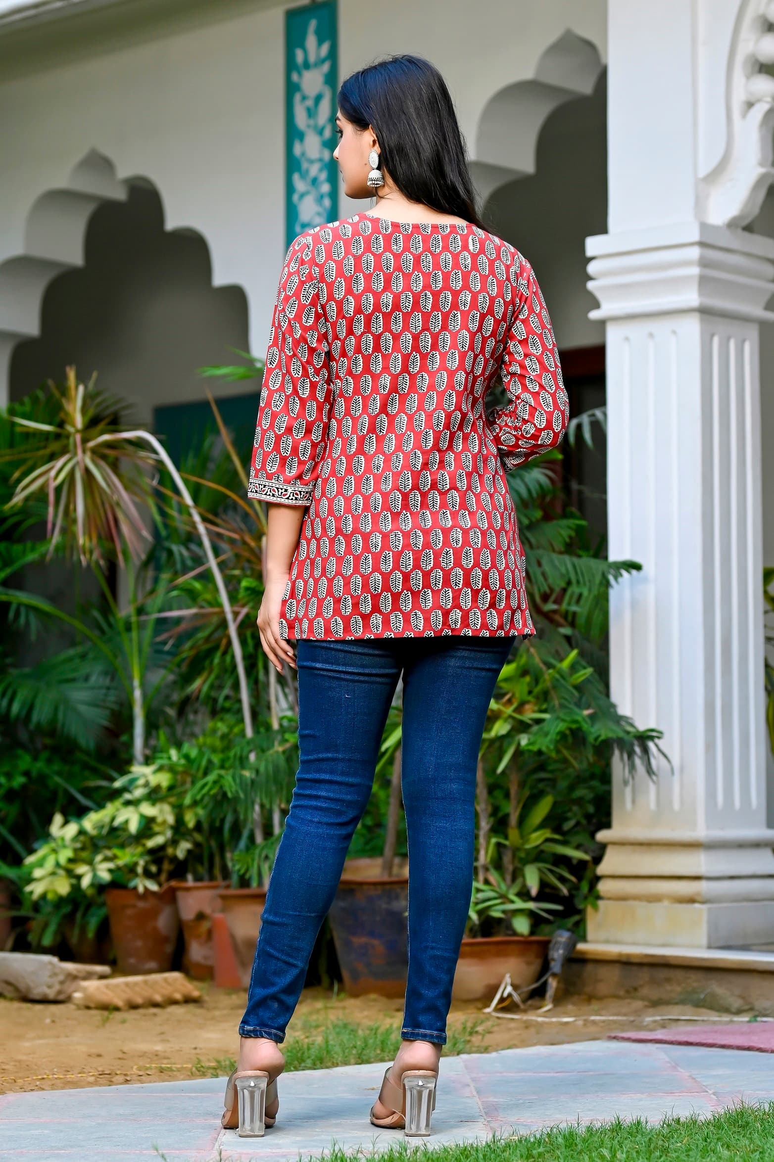 Woman wearing a black kurti set with dupatta by Nishtha Chadda