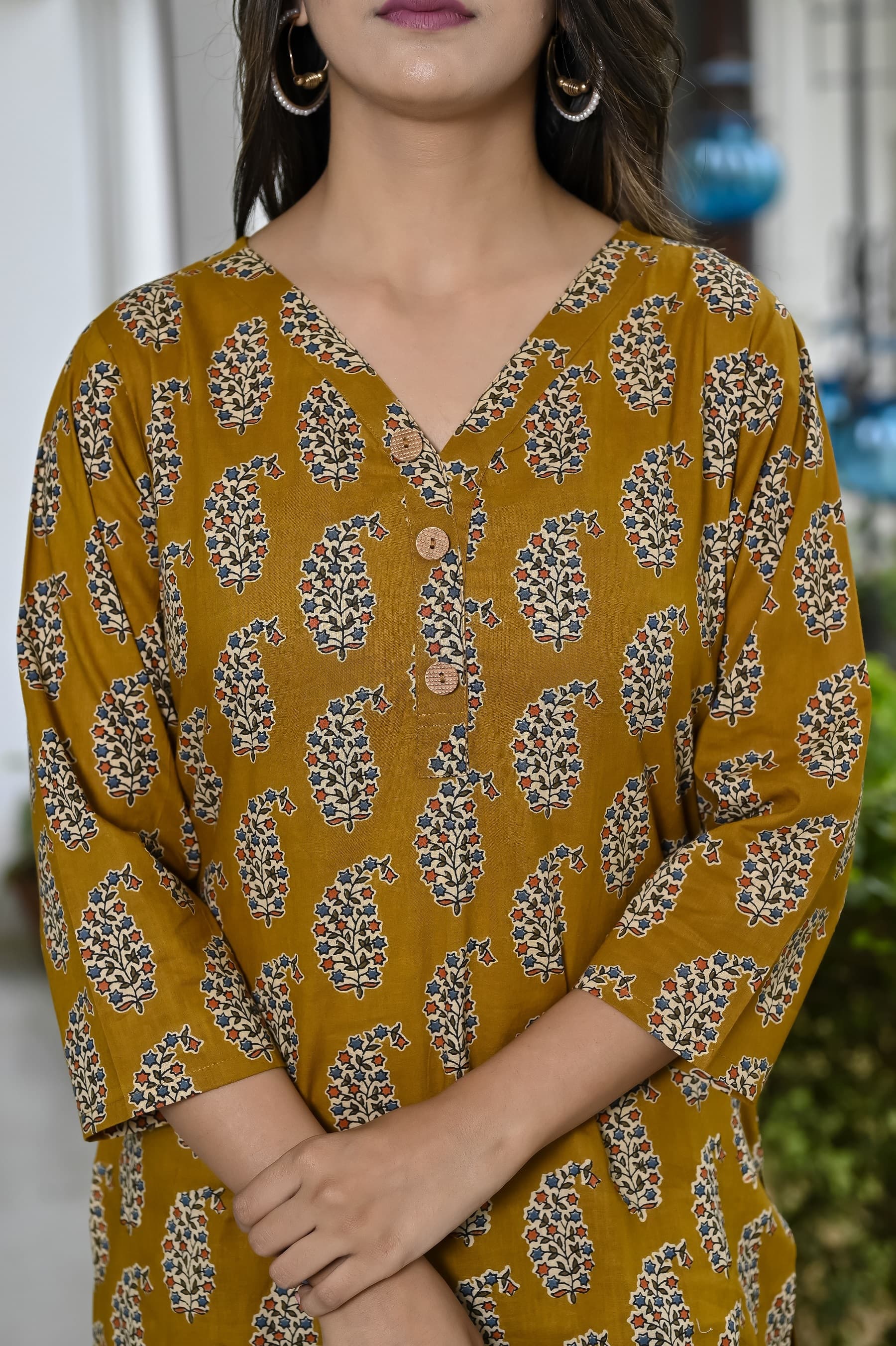 Woman wearing a brown kurti set with dupatta by Nishtha Chadda