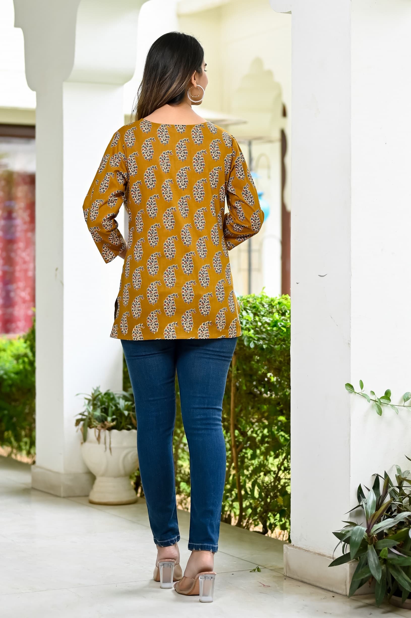 Woman wearing a brown kurti set with dupatta by Nishtha Chadda
